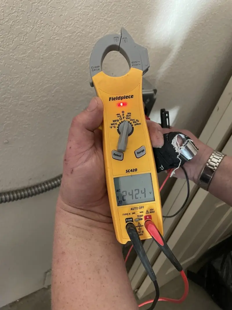 Voltage testing with clamp meter during Electrical Installation Services in Wind Lake